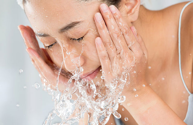 Woman hydrating skin in Bay Area