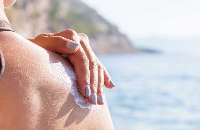 woman applying sunscreen in Bay Area